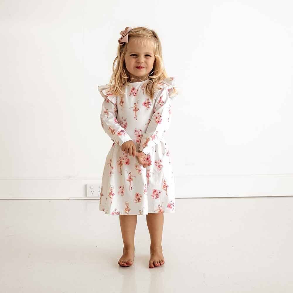 Organic cotton ballerina-style long sleeve dress in soft pink, featuring frilled sleeves and a flared skirt, designed for babies and toddlers.
